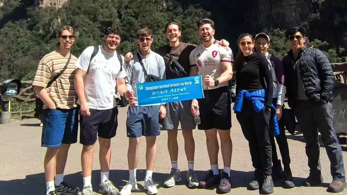 Small group on the Grand Canyon Glass Bridge walkway during a Zhangjiajie China tour, Hunan